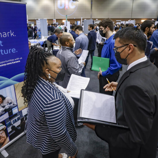 An employer speaking with a student at a past engineering career fair