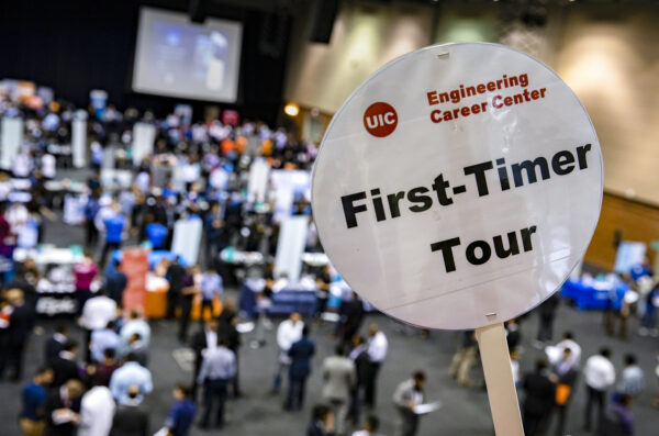 First-Timer Tour sign in a crowded career fair hall