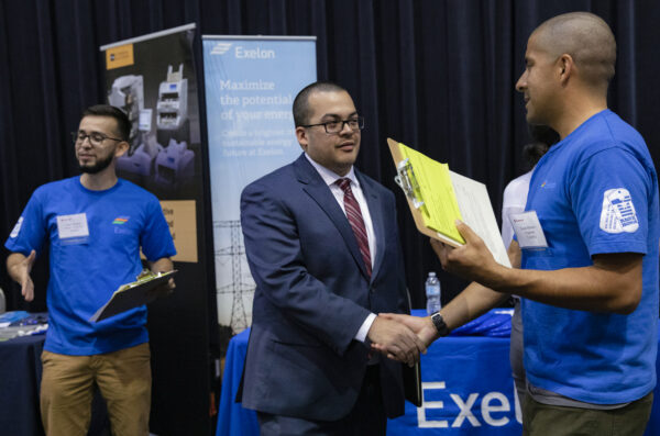 employer and student shaking hands at a job fair